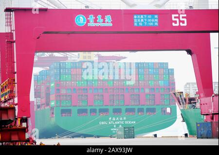 Container ships are docked on a quay at the Port of Qingdao in Qingdao City, east China's Shandong Province on February 11th, 2020. Stock Photo