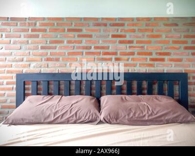 Bedrooms With Exposed Brick Walls Interior Design Ideas.  brick wall behind the bed in red .strong background for an industrial design loft style .hos Stock Photo