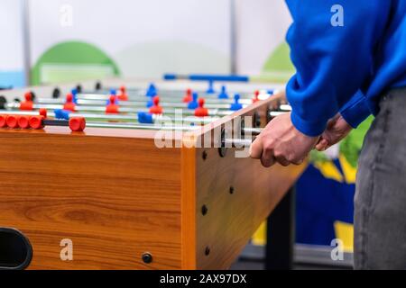 People playing foosball table soccer. Team sport, table football players. Competitive table game Stock Photo