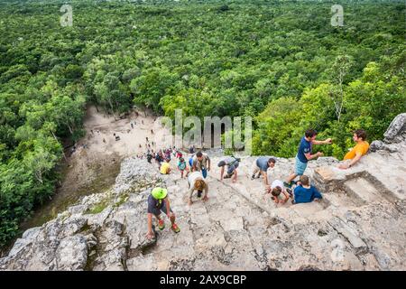 Tourists climbing Nohoch Mul pyramid, Coba Archeological Area, Yucatan Peninsula, Quintana Roo state, Mexico Stock Photo