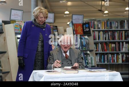 President Michael D Higgins signs some of his own books at Cabra Library in Dublin before he donates part of his personal book collection to Dublin City Libraries. Stock Photo