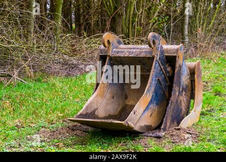 stack of scoops in different sizes, equipment for the excavator, earthmoving industry background Stock Photo