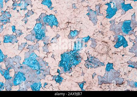 Texture concrete industrial background - light pink and turquoise peeling paint on the old rough concrete surface, peeling paint texture Stock Photo