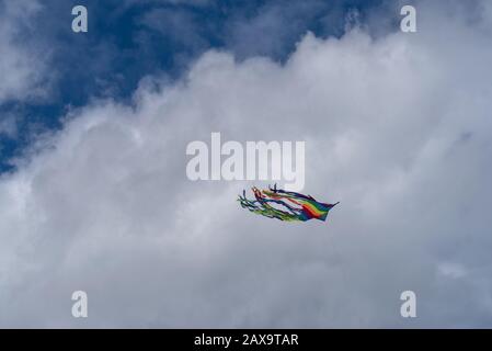 Low angle view of kite flying in cloudy sky Stock Photo