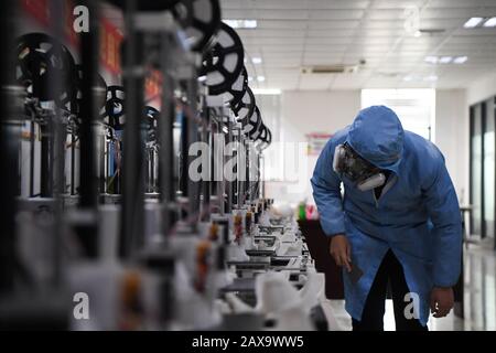 (200211) -- CHANGSHA, Feb. 11, 2020 (Xinhua) -- A worker inspects the operation of 3D printers at the additive manufacturing research and application center of Hunan Vanguard Group Co., Ltd. in the economic development zone of Changsha City, central China's Hunan Province, Feb. 11, 2020. The company has been producing goggles for medical use with more than 50 3D printers working day and night recently. The first batch of 500 pairs of goggles it produced have been sent to Changsha and Huaihua to aid the novel coronavirus control efforts there. (Xinhua/Xue Yuge) Stock Photo