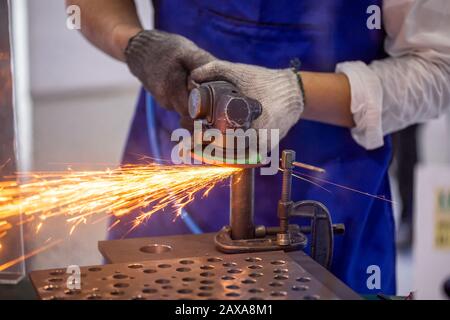 Roofer using a angle grinder to cut a metal. Stock Photo
