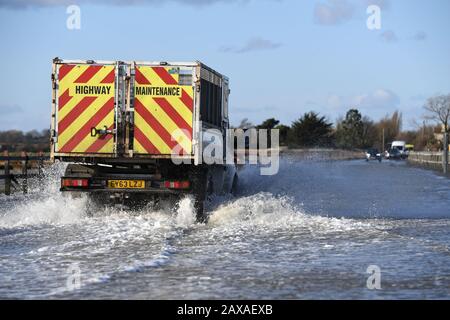 A vehicle travels on The Strood causeway, which joins the mainland to Mersea Island in Essex, to clear as, elsewhere in the UK, rain and wind caused by storm Ciara gave way to hazardous amounts of snow and ice. Stock Photo