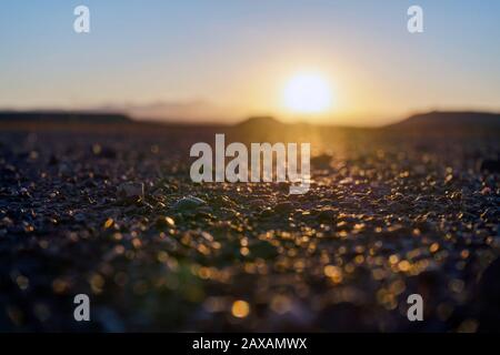 Sunset over barren rocky part of desert in Ouarzazate, Morocco, North Africa Stock Photo