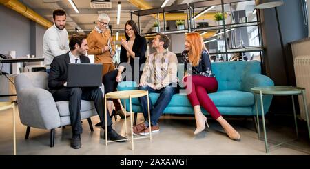Smiling diverse businesspeople talking together in an office Stock Photo