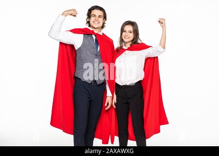 super couple in masks and cloaks standing with crossed arms and looking at camera isolated on grey Stock Photo
