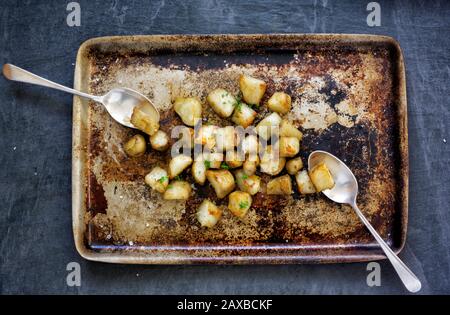 Roasted Jerusalem Artichokes on a roasting tray. Stock Photo