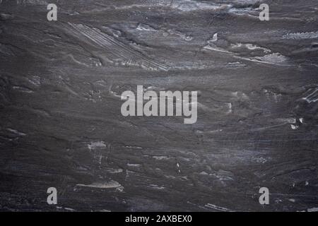 background shabby black-and-gray wall with streaks, textured, three-dimensional texture with a vignette. Stock Photo