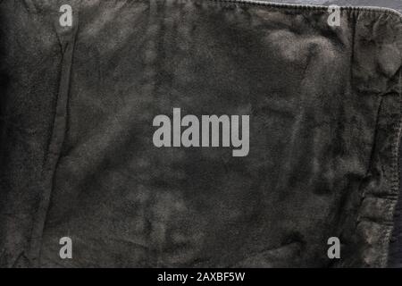 black structural background - old shabby stylish suede, reverse side, old fabric, textile. Stock Photo