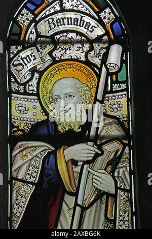 A stained glass window by C E Kempe & Co. depicting St Barnabas, All Saints Church, Braunston, Rutland