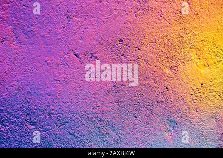 Abstract metal texture with a spray can of paint a gradient of yellow, purple and pink. Close up. Stock Photo