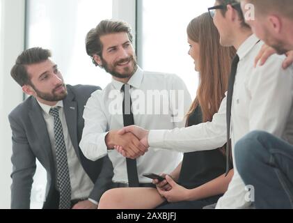 business colleagues shaking hands in the lobby of the business center Stock Photo