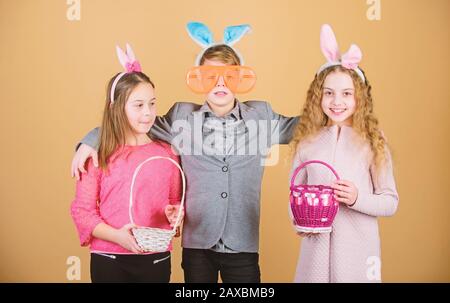 Ready for eggs hunt. Group kids bunny ears accessory celebrate Easter. Children with little basket ready hunting for Easter eggs. Easter activity and fun. Friends having fun together on Easter day. Stock Photo