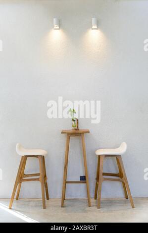 Empty wooden table with two stools Stock Photo