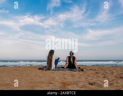 Couple relaxing on tranquil ocean beach Kiama Australia Stock Photo