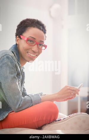 Portrait smiling, confident woman using smart phone Stock Photo