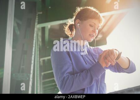 Young female runner checking smart watch Stock Photo