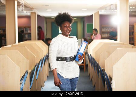 Portrait confident young female college student in computer lab Stock Photo