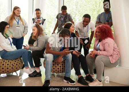 High school students hanging out and using smart phones Stock Photo