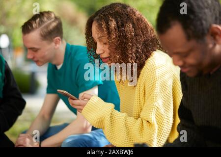 Young female college student using smart phone Stock Photo