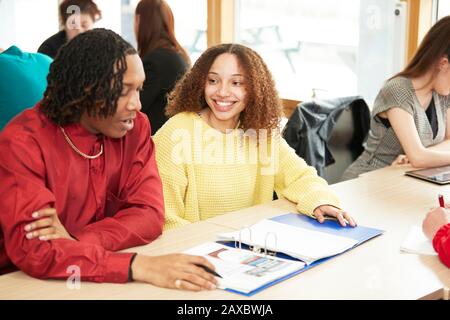 Smiling college students studying in classroom Stock Photo