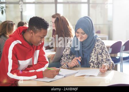 Young college students studying together in classroom Stock Photo