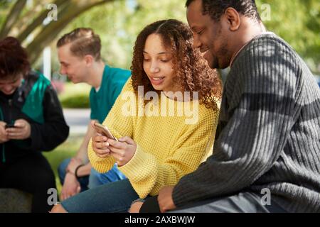 College student friends using smart phone Stock Photo
