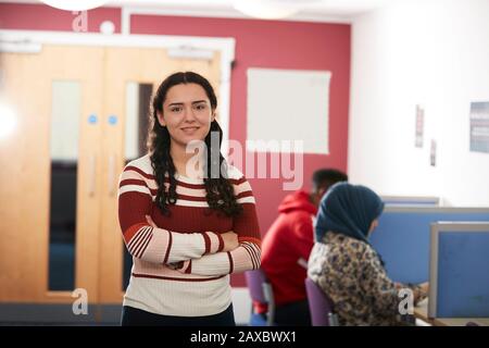 Portrait confident young female college student in library Stock Photo