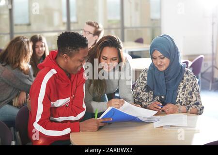 College students studying together in classroom Stock Photo