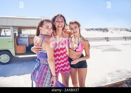 Portrait carefree young women friends on sunny summer beach Stock Photo