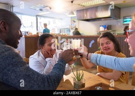 Happy young women with Down Syndrome in cafe Stock Photo