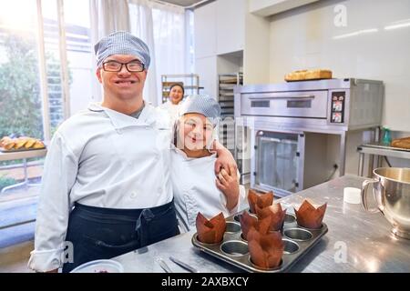 Portrait happy young students with Down Syndrome in baking class Stock Photo