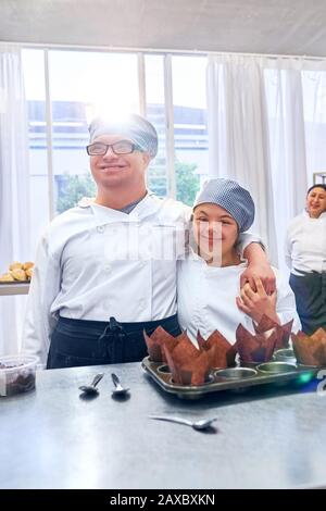 Portrait happy young students with Down Syndrome in baking class Stock Photo
