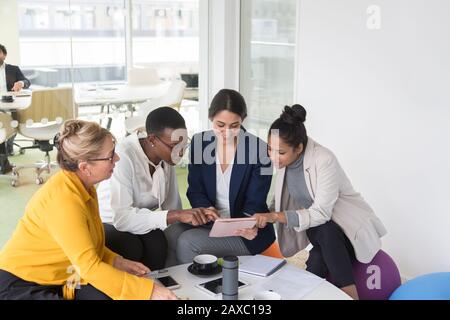 Businesswomen using digital tablet in meeting Stock Photo