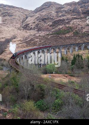 The Jacobite Steam Train crossing Glenfinnan Viaduct en-route from Fort William to Mallaig in Scotland. UK. Stock Photo