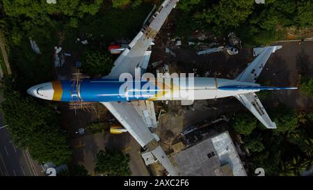 Bekasi, West Java, Indonesia - February 12 2020: SKYLINE AERIAL SHOT. an old airplane on the side of the highway around Bekasi summarecon. repaired wi Stock Photo