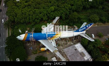 Bekasi, West Java, Indonesia - February 12 2020: SKYLINE AERIAL SHOT. an old airplane on the side of the highway around Bekasi summarecon. repaired wi Stock Photo