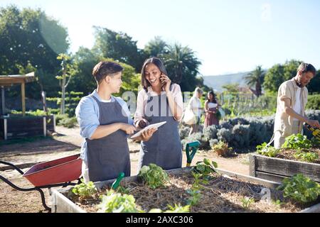 Women with digital tablet working at plant nursery Stock Photo