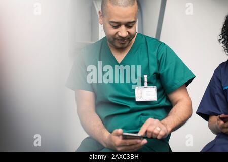 Male surgeon using smart phone Stock Photo