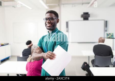 Portrait smiling, confident male community college instructor in classroom Stock Photo