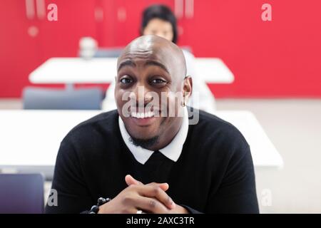 Portrait happy, confident male community college student in classroom Stock Photo