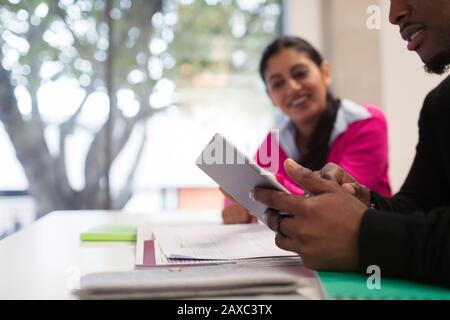 Community college students using digital tablet in classroom Stock Photo