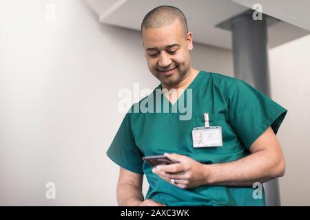 Male surgeon using smart phone Stock Photo