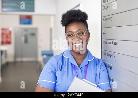 Portrait smiling, confident female nurse in hospital corridor Stock Photo