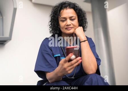 Female doctor using smart phone Stock Photo