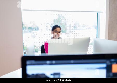 Dedicated female community college student using computer in computer lab classroom Stock Photo